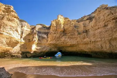 a group of people in a kayak in a cave at Albufeira Central Studio w swim pool and Seaview in Albufeira