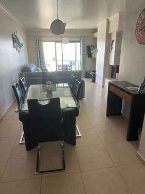 a living room with a table and a couch at Jardins da guia in Albufeira