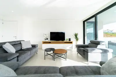 a living room with a couch and a tv at Villa Marina - 33 by HelloVacations in Albufeira