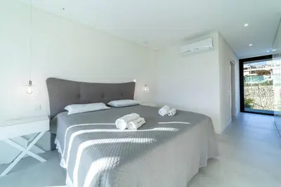 a white bedroom with a bed and a desk at Villa Marina - 33 by HelloVacations in Albufeira