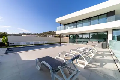 a group of lounge chairs on the roof of a house at Villa Marina - 33 by HelloVacations in Albufeira