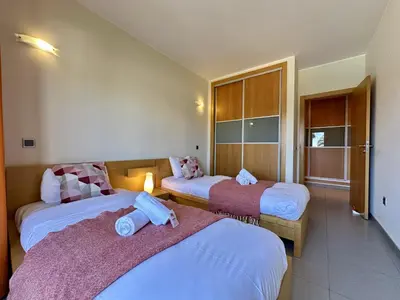 a hotel room with two beds and a balcony at Quarteira Stylish 3 with Pool by Homing in Quarteira