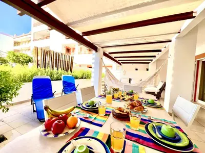 a table with food and drinks on a patio at Vilamoura Grand Terrace with Pool by Homing in Vilamoura