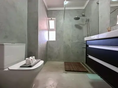 a bathroom with a toilet and a shower with a window at Vilamoura Grand Terrace with Pool by Homing in Vilamoura