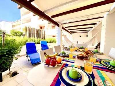 a table with food and drinks on a patio at Vilamoura Grand Terrace with Pool by Homing in Vilamoura