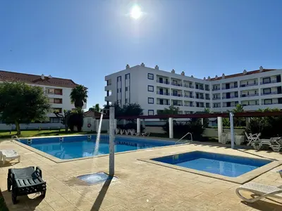 a swimming pool in front of a large building at Vilamoura Grand Terrace with Pool by Homing in Vilamoura