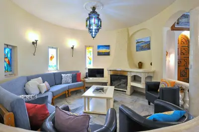 a living room with couches and a fireplace at Villa Atlantico in Quarteira