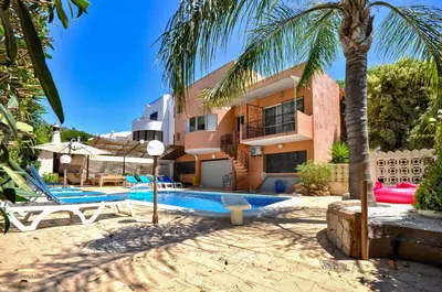 a resort with a swimming pool and a building at Villa Atlantico in Quarteira