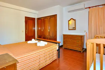 a bedroom with a bed with two towels on it at Villa Gardenia in Quarteira