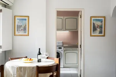 a kitchen with a table with a plate of food on it at LUIS - Vilamoura in Vilamoura