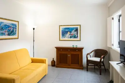 a living room with a couch and a chair at LUIS - Vilamoura in Vilamoura