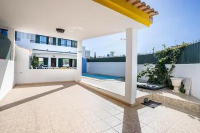 a living room with a couch and a tv at #039 Family Private Pool AC in Albufeira