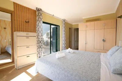 a bedroom with a bed and a mirror at #039 Family Private Pool AC in Albufeira