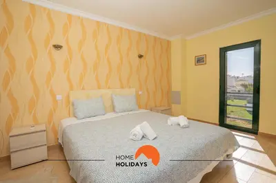 a bedroom with a bed with towels on it at #039 Family Private Pool AC in Albufeira