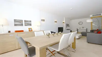 a dining room and living room with a table and chairs at Aquamar 15 - Clever Details in Vilamoura