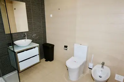 a bathroom with a tub and a sink and a toilet at Aquamar 15 - Clever Details in Vilamoura