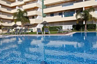 a swimming pool in front of a building at Aquamar 15 - Clever Details in Vilamoura