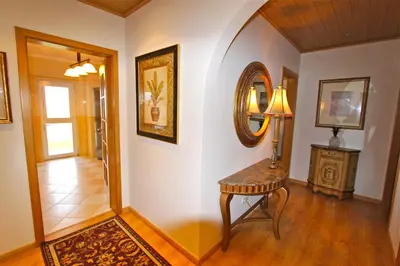 a hallway with a table and a mirror on a wall at Antelius 82 - Clever Details in Vilamoura