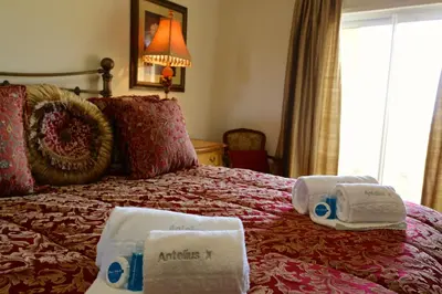 a hotel room with a bed with towels on it at Antelius 82 - Clever Details in Vilamoura