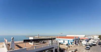 a view of a city with the ocean in the background at Residencial Miramar in Quarteira