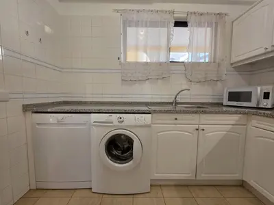 a kitchen with a washing machine and a sink at Marina Mar Retreat by SAPvillas in Vilamoura