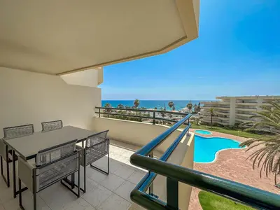 a balcony with a slide and a swimming pool at Luxury Apart wStunning Sea Views, walk Galé Beach Albufeira in Albufeira