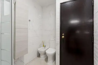 a bathroom with a toilet and a glass shower at Estúdio 21 em Santa Bárbara de Nexe - Faro in Santa Bárbara de Nexe