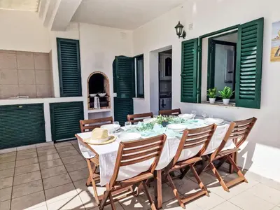 a living room with a couch and a table at Holiday Home V2 Caliços - VIP Properties by Interhome in Albufeira