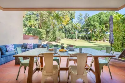 a patio with a table and chairs and a couch at 2 bedroom Vila Sol Golf Resort in Quarteira