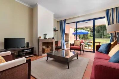 a living room with a couch and a table at 2 bedroom Vila Sol Golf Resort in Quarteira
