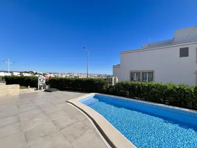 a swimming pool in front of a building at Albufeira Stylish 2 With Pool by Homing in Albufeira