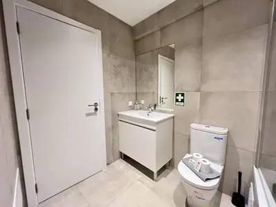 a bathroom with a toilet and a sink at Albufeira Stylish 2 With Pool by Homing in Albufeira