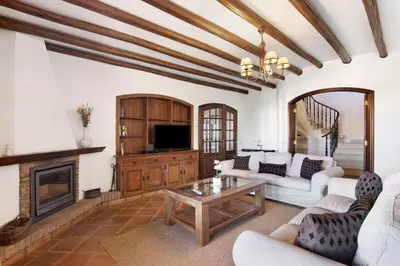 a living room with a couch and a fireplace at Villa Rústica in Albufeira