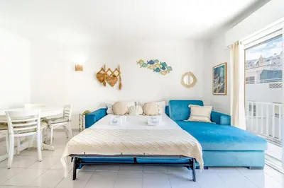 a bedroom with a blue bed and a table at Stay in Old Town - 5 min walking to the beach in Albufeira