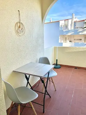 a table and two chairs sitting on a patio at Casa Caki - A 15 minutos da praia in Albufeira
