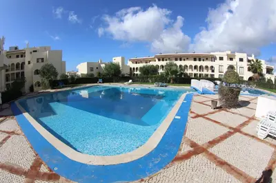 a large swimming pool in front of a building at Casa Caki - A 15 minutos da praia in Albufeira