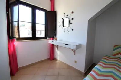 a bedroom with a dressing table and a window at Old Town Apartments 2D in Albufeira