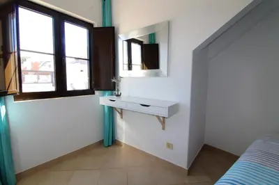 a bedroom with a sink and a mirror and a bed at Old Town Apartments 2D in Albufeira