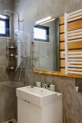 a bathroom with a sink and a shower and a mirror at Casa da Calma, Vale do Lobo in Almancil