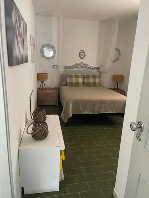 a small bedroom with a bed and a table at Villa Snoppy in Albufeira