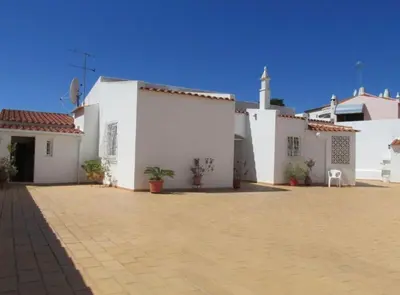 a group of white buildings with a church at Villa Snoppy in Albufeira