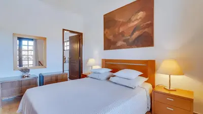 a bedroom with a white bed and a mirror at Villa Frederique in Albufeira