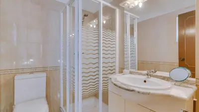 a bathroom with a sink and a toilet and a shower at Villa Frederique in Albufeira