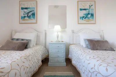 two beds sitting next to each other in a bedroom at ELI FLAT just few steps from the Strip in Albufeira in Albufeira