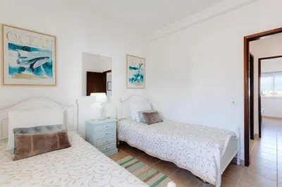 a bedroom with two beds and a mirror at ELI FLAT just few steps from the Strip in Albufeira in Albufeira