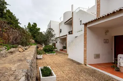 a house with a stone pathway next to a building at Estúdio 24 em Santa Bárbara de Nexe - Faro in Colmeal