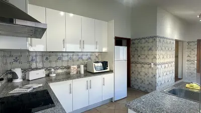 a kitchen with white cabinets and a white refrigerator at Vilanova by Check-in Portugal in Albufeira