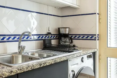 a small kitchen with a sink and a stove at TAC - Cerro Belo in Albufeira