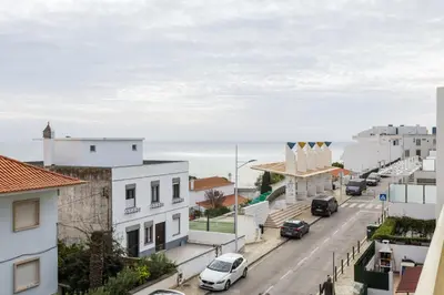 a city street with buildings and the ocean in the background at TAC - Cerro Belo in Albufeira