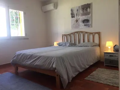 a bed in a bedroom with two lamps and a window at Luxury Villa private pool, Albufeira in Albufeira